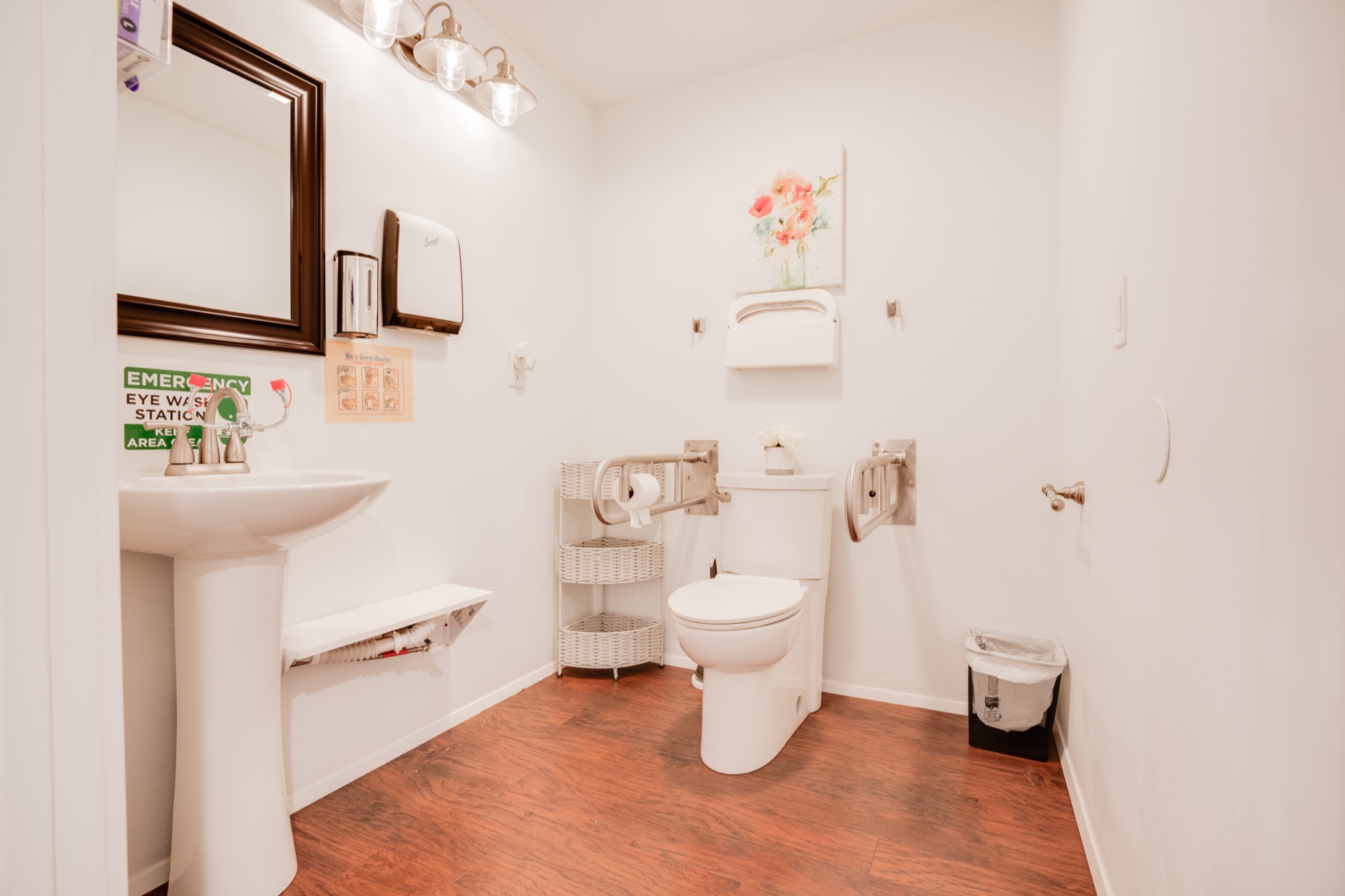 Wheelchair-accessible bathroom with grab bars and safety rails